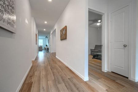 Corridor with light wood-type flooring