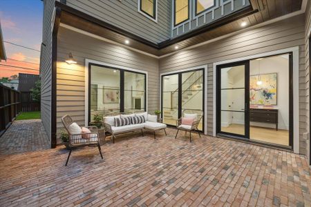 There is a lovely courtyard entrance with brick pavers, lighting, and a sitting area.  There is also a gas and water connection is this area.  The Patio is Approx. 17 x 16 per builders plans.