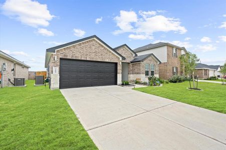 This is a modern single-family home featuring a One-story design with a brick facade, a two-car attached garage, and a well-maintained lawn.
