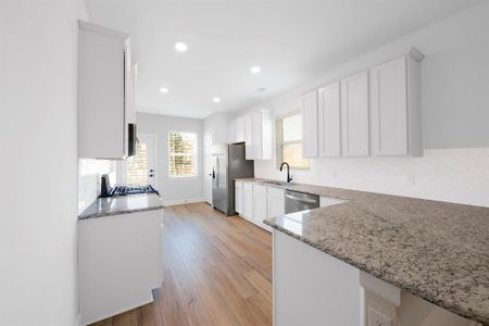 Featuring timeless white cabinets, stainless steel appliances, and granite countertops, the kitchen embodies classic design elements that never go out of style, ensuring enduring beauty and versatility for years to come.