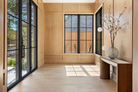 Past the custom steel and glass front door, the foyer's floor-to-ceiling rift sawn white oak paneling not only adds a touch of natural warmth to the space but also showcases the exquisite craftsmanship that went into every detail of this home.