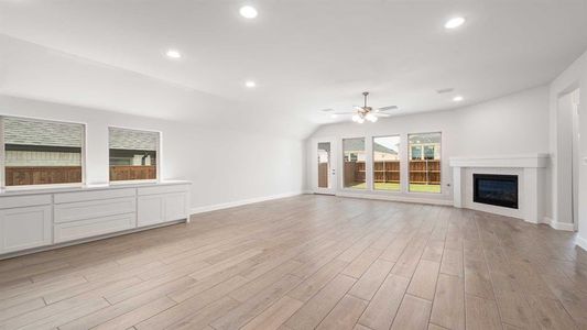 Unfurnished living room with ceiling fan and light hardwood / wood-style floors