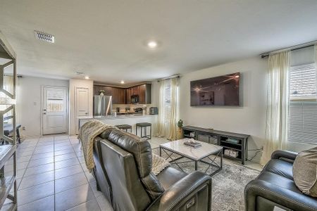 Living room featuring light tile patterned flooring and a healthy amount of sunlight