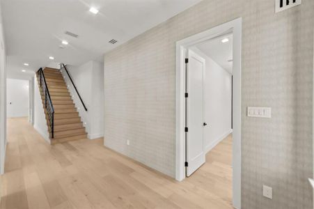 Hallway with light hardwood / wood-style floors