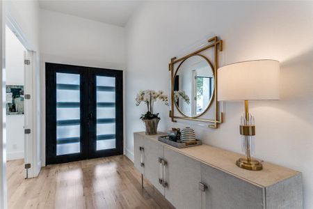 Foyer featuring light hardwood / wood-style floors and french doors