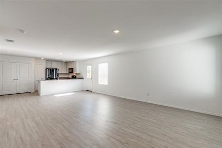 Unfurnished living room with light wood-type flooring