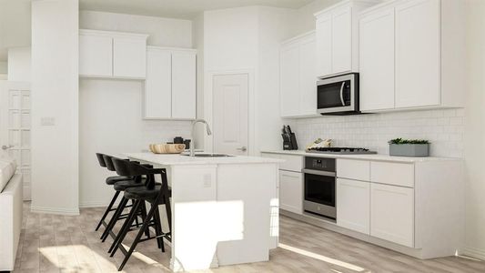 Kitchen with a center island with sink, appliances with stainless steel finishes, white cabinetry, light wood-type flooring, and sink