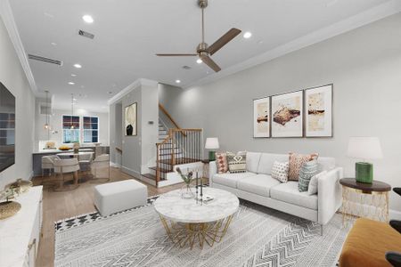 This virtually staged image beautifully highlights the abundant space available in this townhome. The open floor plan effortlessly connects the family room, dining area, and kitchen, creating an ideal environment for both everyday living and entertaining.