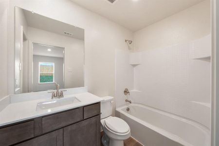 Full bathroom featuring wood-type flooring, toilet, vanity, and shower / washtub combination