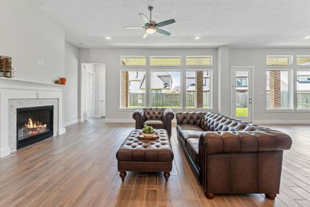 The living room of this home presents a captivating picture of comfort and style. The open concept floorplan seamlessly integrates the living area with the surrounding spaces, creating an inviting environment for relaxation and socializing.