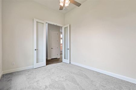 Spare room featuring carpet floors and ceiling fan