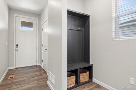 View looking at front door, coat storage