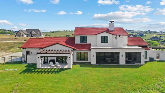 Rear view of property featuring a patio, central air condition unit, and a lawn