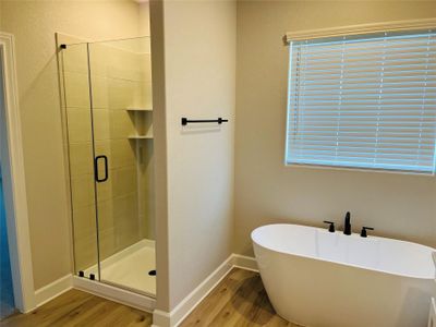 Master bathroom includes granite countertop, elongated mirror, and dual-vanity sinks. Relax in the large soaking tub or enjoy the spacious, standing shower.