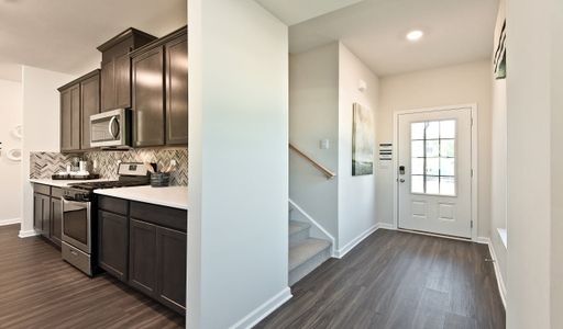 Foyer leads to open-concept living area.