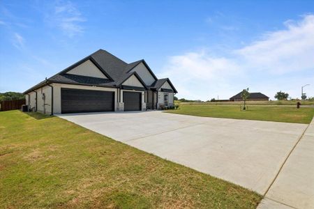 Craftsman-style house with a garage, a front lawn