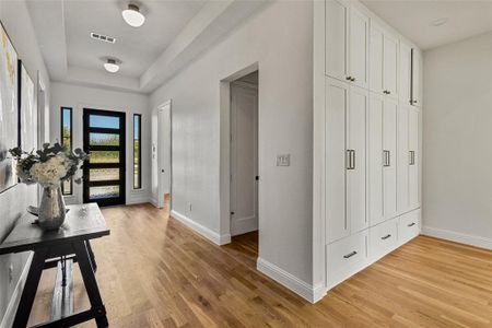 Foyer with light hardwood / wood-style floors