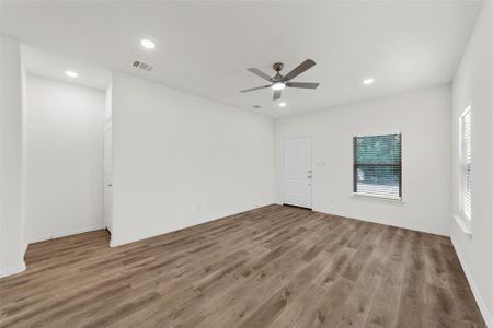 Unfurnished room featuring hardwood / wood-style floors and ceiling fan