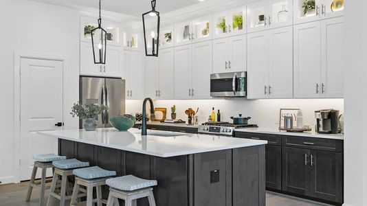 The kitchen features cabinets that extend to the ceiling, providing ample storage space and a sleek, modern look. There are a total of 27 cabinets in the kitchen, not including the 14 glass upper cabinets, ensuring plenty of storage options.