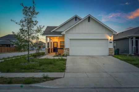 View of front of property featuring a garage and covered porch