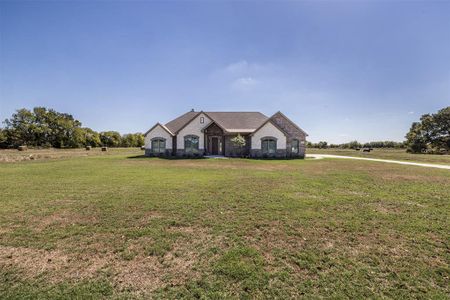 French country home with a front yard