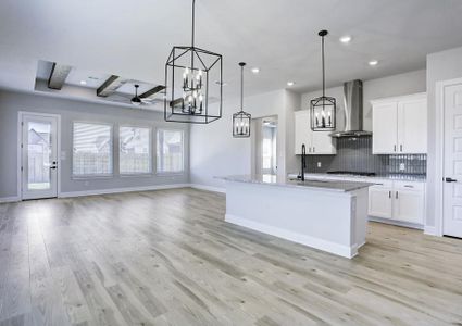 Bright, open layout with the kitchen, dining area, and living room connected.