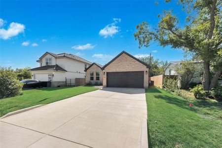 Ranch-style house featuring a front yard and a garage