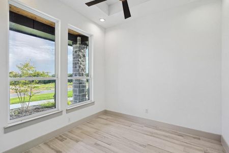 Unfurnished room with ceiling fan and light hardwood / wood-style flooring