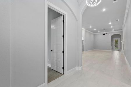 Hallway featuring ornamental molding