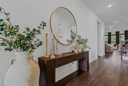 Corridor with an inviting chandelier and dark hardwood / wood-style flooring