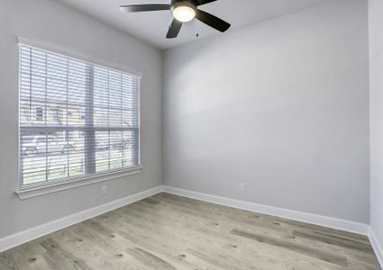 Study located off of the entry with large windows peering out into the front.