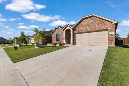 View of front of house featuring central AC, a front lawn, and a garage