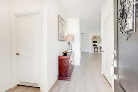 UPON ENTRY, YOU ARE GREETED BY A LIGHT AND BRIGHT FOYER WITH GORGEOUS VINYL FLOORING AND LEADS DIRECTLY INTO THE OPEN LIVING AREA.