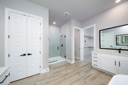 Located in the back corner of the home, the master bedroom has an array of enviable features including an impressive bathroom with a standalone tub, a walk-in shower and sizable walk-in closet.