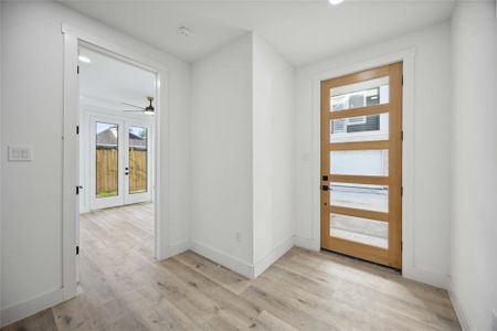 Welcoming entryway features a contemporary front door with glass panels, allowing natural light to flood the space. Private bedroom and bathroom with access to backyard on main floor, ideal for multigenerational living or roommates.