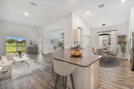 Sweetwater new construction home plan interior open concept family room and kitchen area at Lanier Acres in Zephyrhills, Fl by William Ryan Homes Tampa