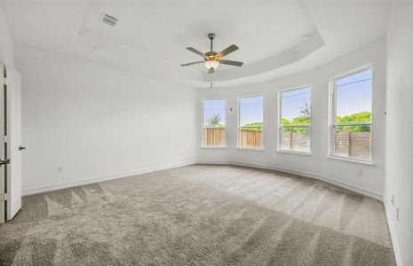 Elegant owner's suite with bay window *real home pictured