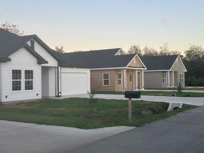 Single story home with a lawn and a garage