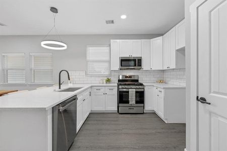 Open Kitchen with stainless steel appliances, custom cabinets, and separate pantry.