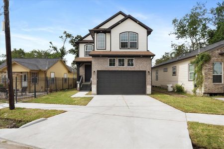 This home boasts a brick and hardi plank exterior, soffit lighting all around, and a covered front porch. The two-car garage includes windows for extra natural light and features high ceilings.