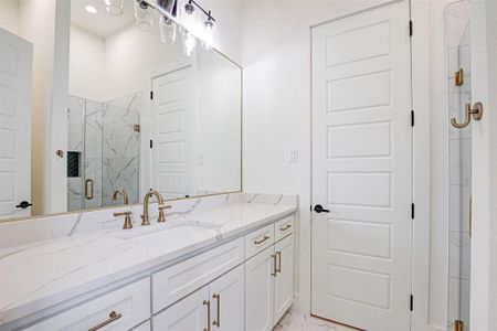 Bathroom featuring vanity and an enclosed shower