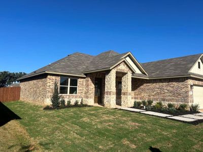 View of front of property with a garage and a front lawn