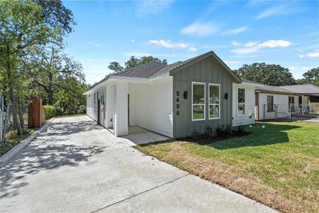 View of property exterior featuring a lawn and a garage