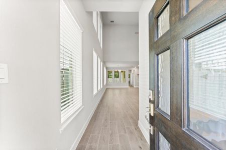 Beautiful, well-kept wood tile and lots of natural light greets you with a view of the greenbelt.