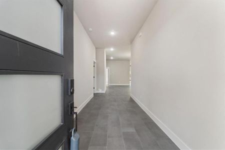 Upon entering, you’ll be welcomed by tile flooring and soaring 10-foot ceilings. To your left are bedrooms #1 and #2. Straight ahead, the open-concept layout unfolds, featuring the dining, living, and kitchen areas.