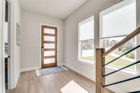 Enter to a spacious foyer with large windows that provide a great view of the adjacent green space.  Most windows in this home have unique top-down, bottom-up blinds.