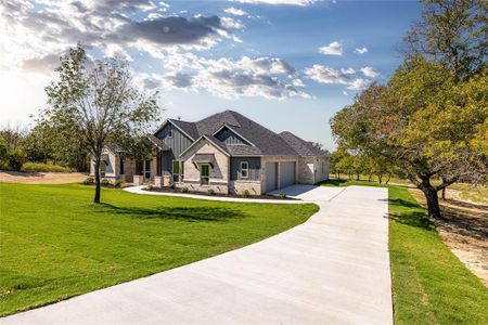 Craftsman house with a garage and a front yard