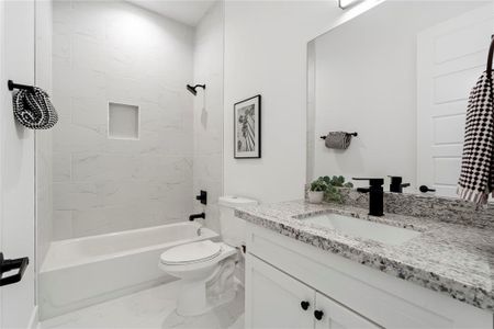 The downstairs full bathroom offers convenience and accessibility for your guests