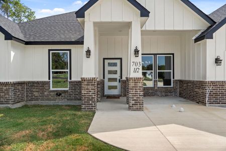 View of exterior entry featuring a yard