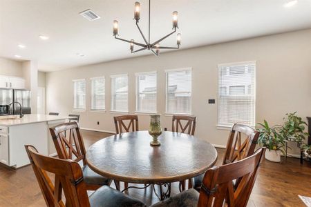 Notice the new and stylish light fixture in the dining room. A round table or a rectangular one works real well in this space.